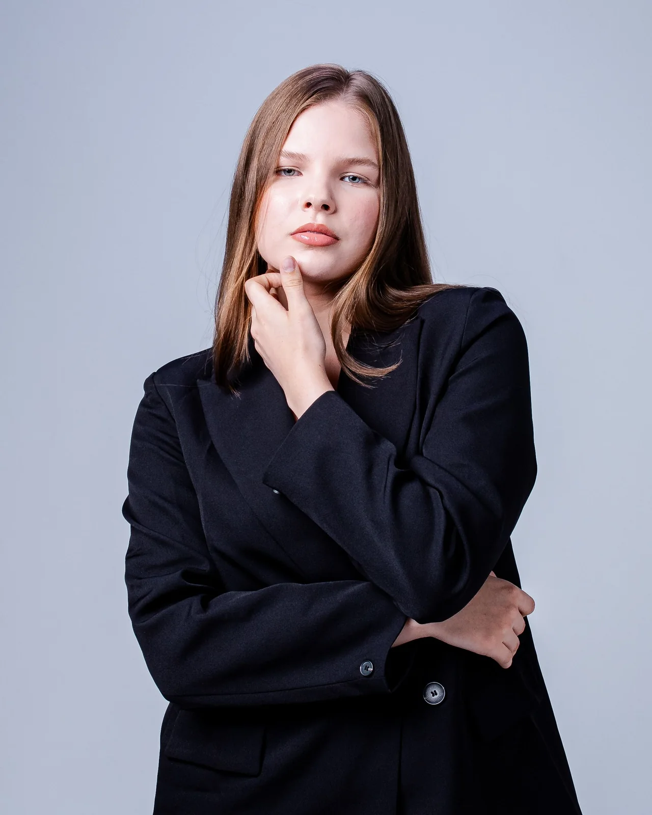 Model wearing a structured black blazer in a studio