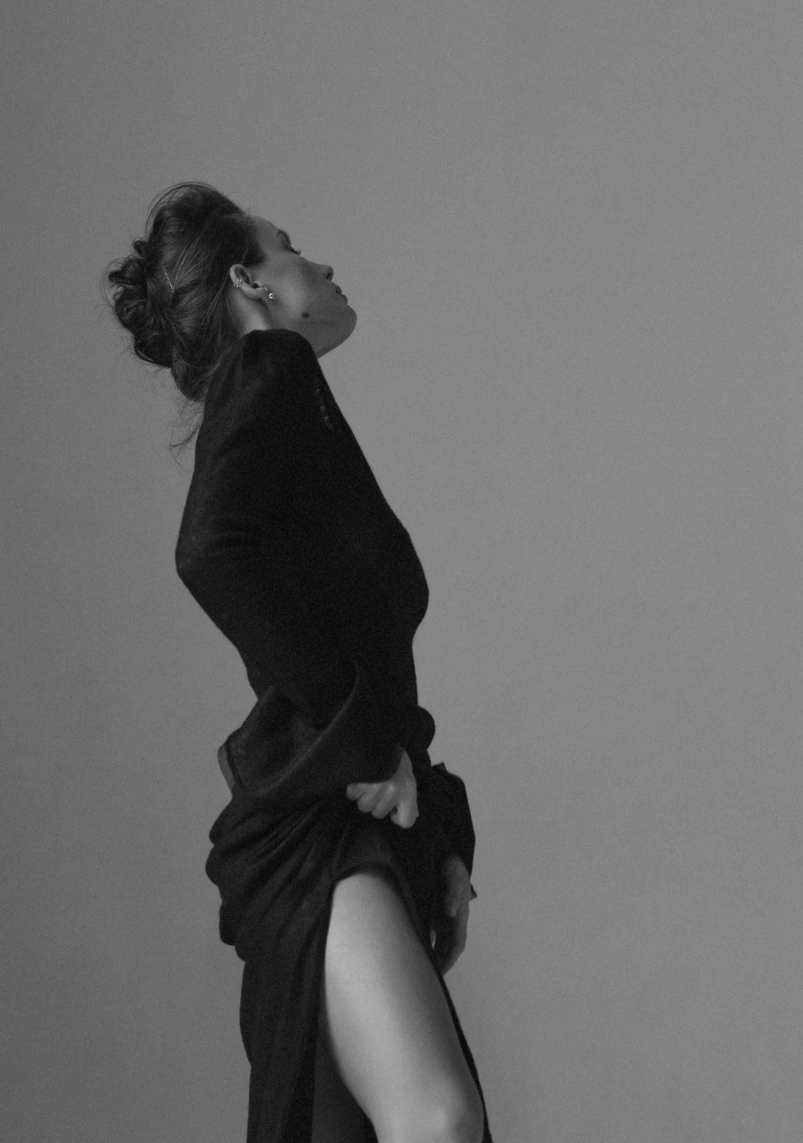 Model wearing a sculptural black dress